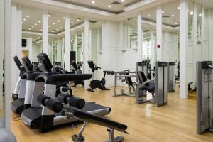 a gym with several treadmills and exercise bikes at Versace Tower Luxury Suites - Downtown in Beirut