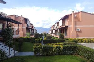 a row of buildings with bushes and a garden at Luxury Beach House 3 Br, AC in Selianitika