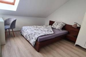 a small bedroom with a bed and a chair at Ganze 2-Raum Ferienwohnung Links in Baderitz