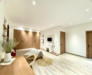 a living room with white walls and a wooden floor at Sushi House Ba Dinh homestay alley38 Hang Bun in Hanoi +22 photos