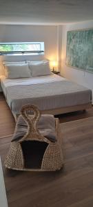a bedroom with a large bed with a basket on the floor at Cosy loft in Platamonas