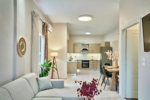 a living room and kitchen with a couch and a table at Luxurious house near the sea in Kato Daratso