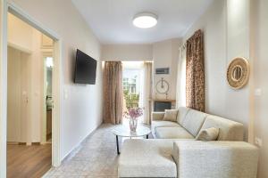 a living room with a couch and a table at Luxurious house near the sea in Kato Daratso