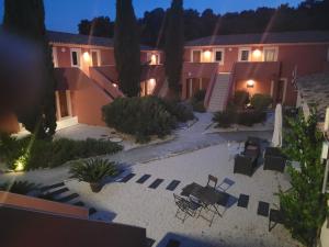 a courtyard of a house with chairs and lights at Hôtel Domaine le Milos in Castries