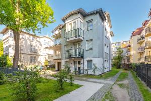 an apartment building with a walkway in front of it at Lion Apartments - Chopina 29 with parking 5 min from the beach and Center in Sopot