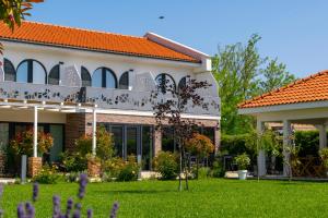 a house with a garden in front of it at Boutique 23 in Douăzeci şi Trei August