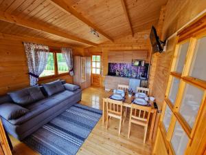 a living room with a couch and a table at Pod Lawendą & Jacuzzi & Blisko Augustów in Augustów