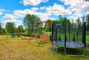 a playground with two swings and a swing set at Pod Lawendą & Jacuzzi & Blisko Augustów in Augustów +8 photos