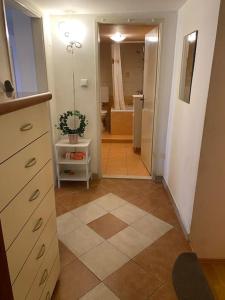 a bathroom with a vanity and a bathroom with a shower at Cozy & quiet studio apartment with a garden in Split