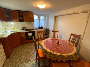 a kitchen with a table and a kitchen with a table and chairs at Cozy & quiet studio apartment with a garden in Split