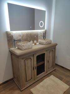 a bathroom with a sink and a mirror at Le Domaine De Dolly in Villeneuve-sur-Lot