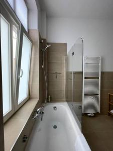 baño con bañera y ventana en LUCKY STAYS LS04 - 2 Zimmer - Luxus - Zentrum - große Küche - Aufzug - Smart-TV en Magdeburgo
