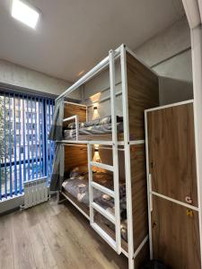 a bunk bed room with two bunk beds in it at izzzi hostel in Bishkek