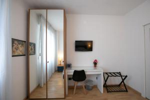 a mirror in a room with a desk and a chair at Mirea's Rooms in Ascoli Piceno