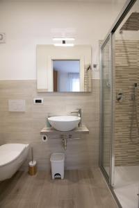 a bathroom with a sink and a toilet and a shower at Mirea's Rooms in Ascoli Piceno