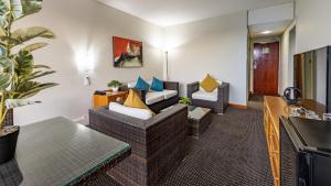 a hotel room with two couches and a living room at African Sky Harrismith Inn in Harrismith