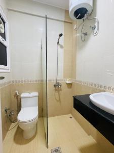 a bathroom with a toilet and a sink at Husin Al Khaleej Hotel Apartment in Seeb +64 photos