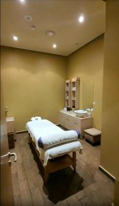a bedroom with a large bed and a bathroom at Marina Cape surprise studio in Aheloy