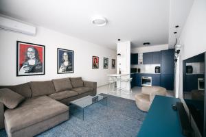 a living room with a couch and a table at Taormina Art Apartment by Taormina Holidays in Taormina