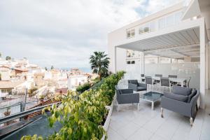 a balcony with furniture and a view of the city at Taormina Art Apartment by Taormina Holidays in Taormina