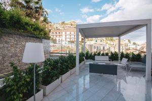 a pavilion with a table and chairs on a balcony at Taormina Art Apartment by Taormina Holidays in Taormina