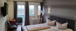 a hotel room with a bed and a window at Pension Villa Irene in Kurort Gohrisch +33 photos