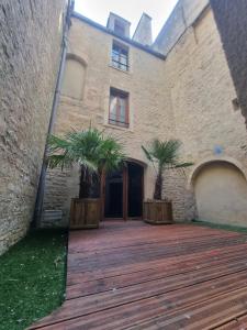 a building with two palm trees in front of it at La Bayeuzen - La Tropicale - Love Room in Bayeux