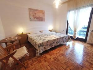 a bedroom with a bed and a large window at Apartments Marijana in Vodice