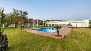 a house with a swimming pool in a yard at African Sky Harrismith Inn in Harrismith