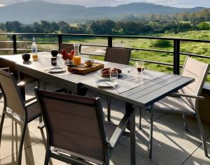 a table and chairs on a balcony with a view at Appart T3 4 étoiles 4/6 personnes Porto Vecchio in Porto-Vecchio