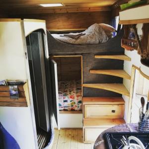 a bedroom with a bunk bed in a tiny house at Truck & Pod creative nature retreat. in Bantry