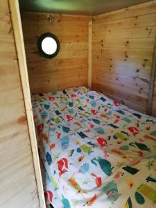 a bed in a wooden frame in a room at Truck & Pod creative nature retreat. in Bantry