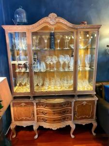 a wooden cabinet with glasses in it at Høy standard. Mye for pengene. Gratis velkomstgave in Narvik