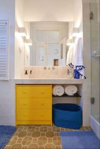 a bathroom with a sink and a yellow cabinet at Alfama Modern Cosy Home in Lisbon