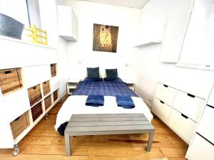 a bedroom with a bed with blue pillows at Alfama Modern Cosy Home in Lisbon