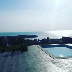 a swimming pool with a view of the ocean at Apartma Lima in Ankaran