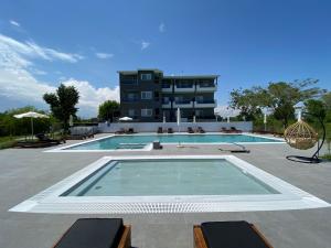 a large swimming pool in front of a building at Olympus Diamond studios in Olympic Beach