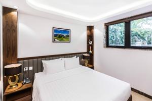 Ένα ή περισσότερα κρεβάτια σε δωμάτιο στο Blubiz Hotel Mỹ Đình (Blubiz Hotel 2)