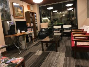 a waiting room with tables and chairs in a store at Aizu Tsuruya Hotel in Aizuwakamatsu