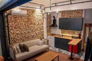 a living room with a couch and a brick wall at Alness Residence in Istanbul