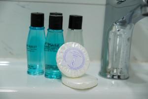 a white counter with three bottles of soap and a sucker at hotel La Vitrine in Istanbul