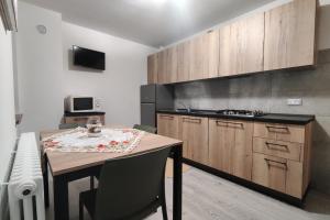 a kitchen with a table and a stove top oven at Tur Appartamenti in Padola +37 photos