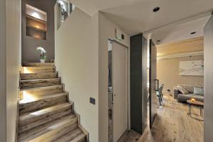 a stairway leading to a living room in a house at Lux Domotic Apt-Chalet Dolomites in Pinzolo