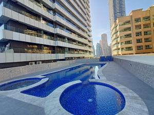 a swimming pool in the middle of a building at Escan Marina Tower Apartment in Dubai