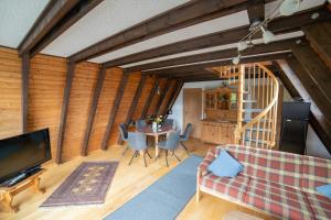 a living room with a couch and a table at Ferienhaus Rhön-Auszeit in Bischofsheim an der Rhön