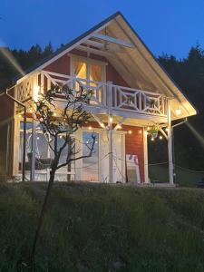 a small house with a porch at night at Forest house in Targanice