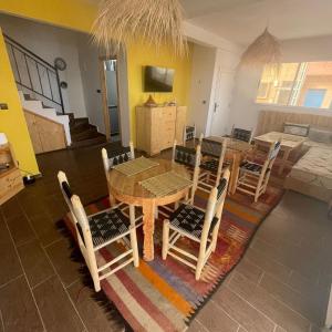 a kitchen and dining room with a table and chairs at Dar Mouja, eco-friendly home in Imsouane