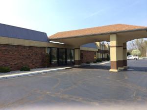 an empty parking lot in front of a building at Days Inn by Wyndham Albion in Albion