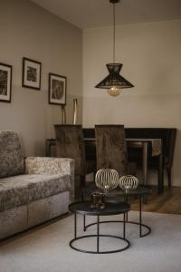 a living room with a couch and a table at Boutiquehotel Minigolf in Tirolo