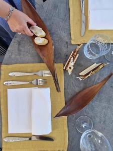 a person holding a knife and fork on a table at Fantinello Hotel in Caorle